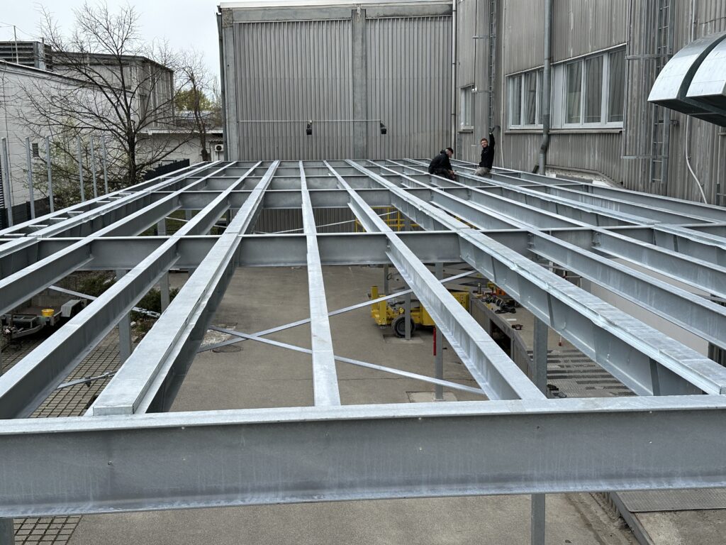 a metal structure with people standing around