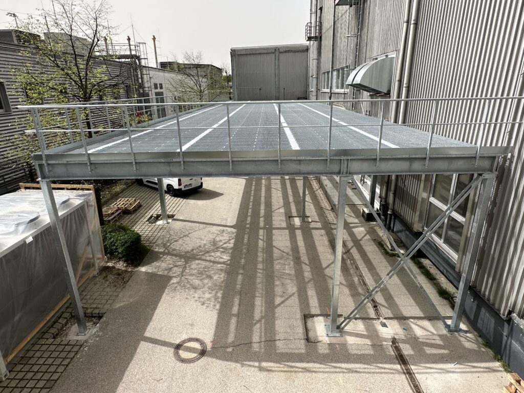 a metal platform with a railing