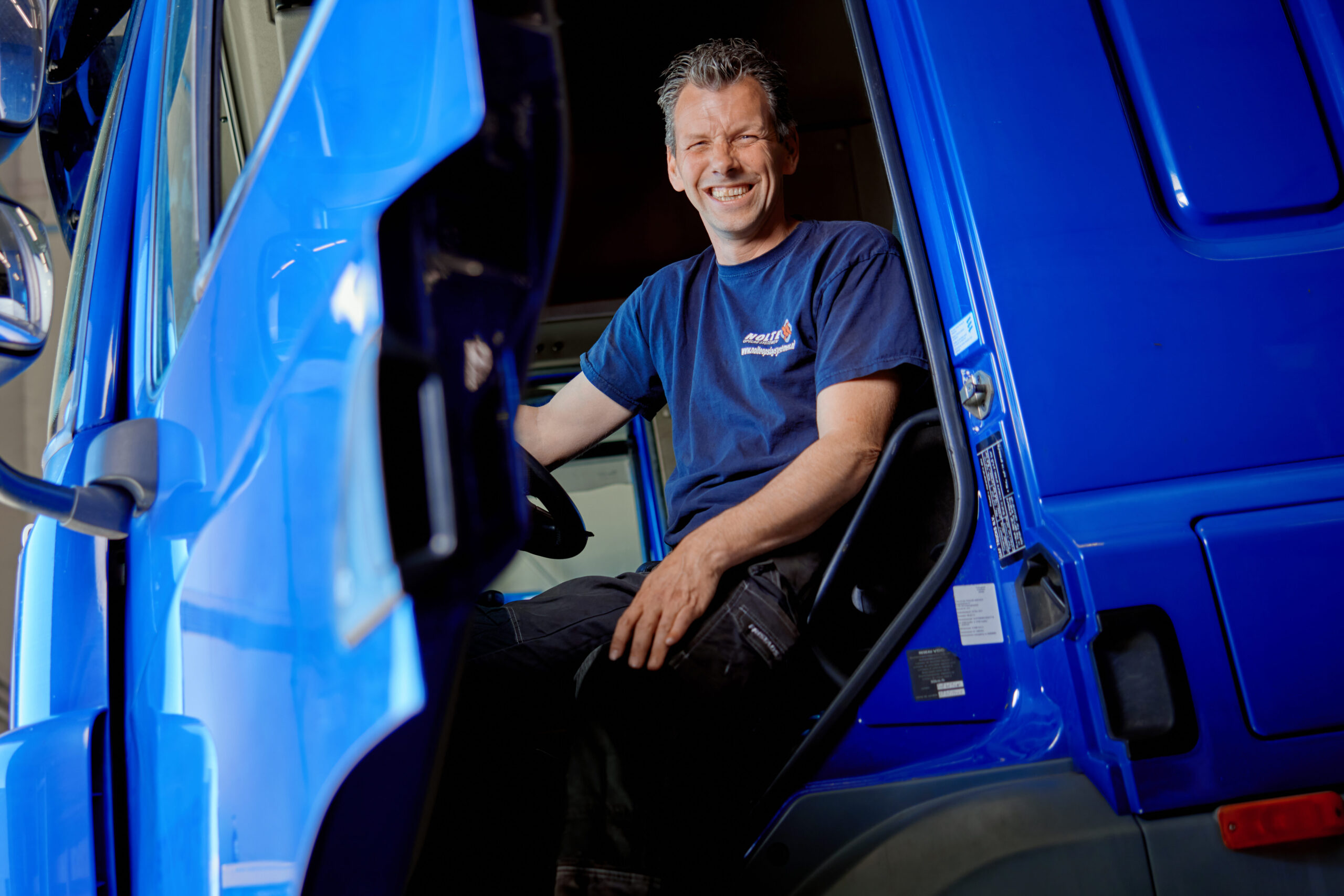 a man sitting in a blue truck
