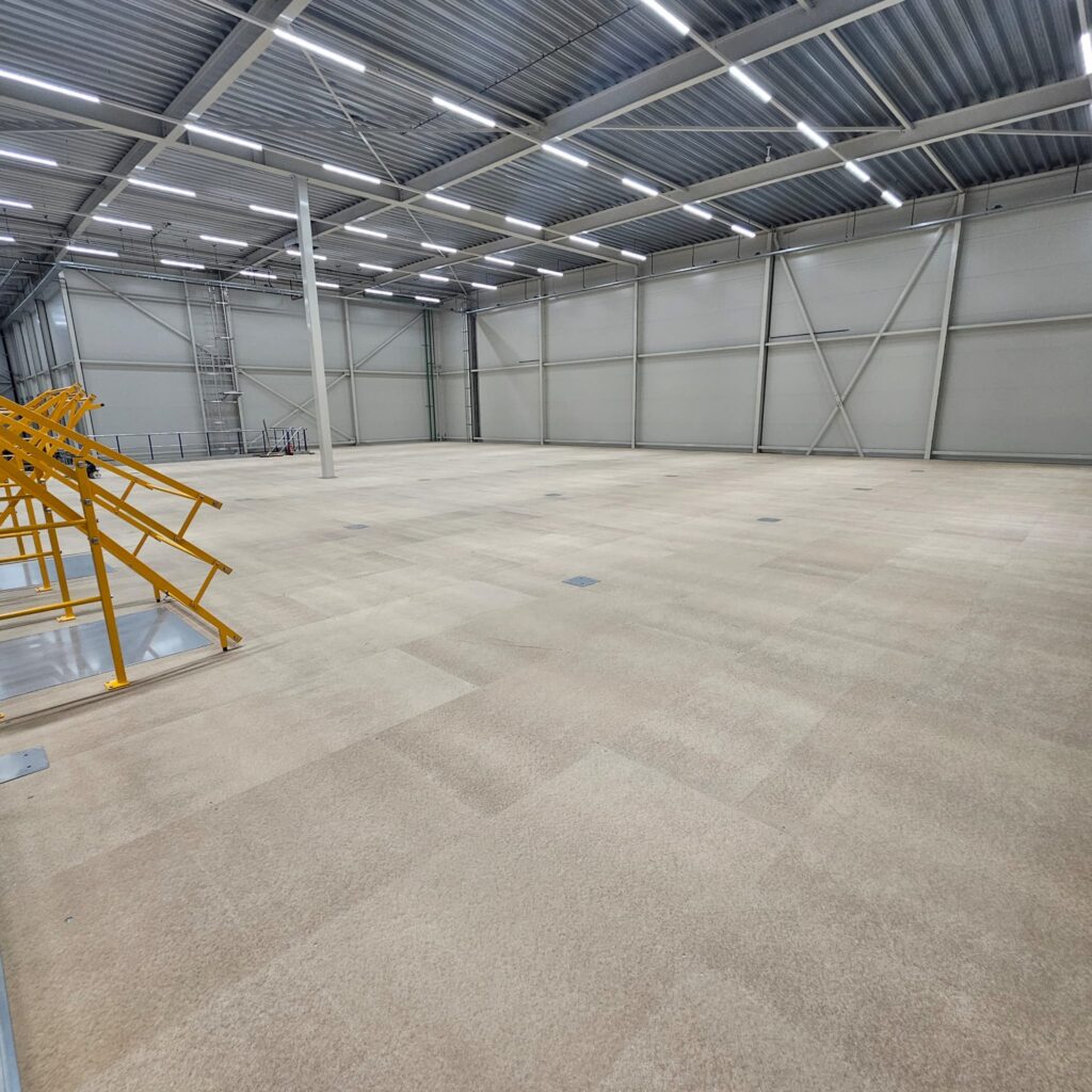 a large empty warehouse with metal stairs
