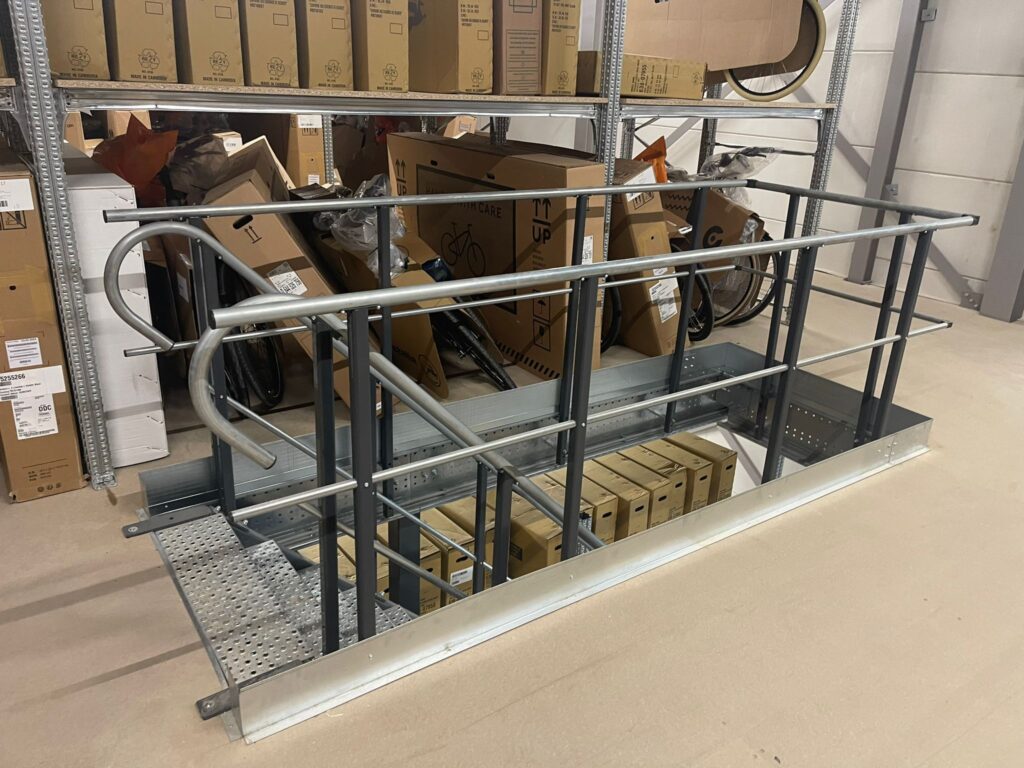 Mezzanine vloer met stalen leuning en trapgat op maat in magazijn